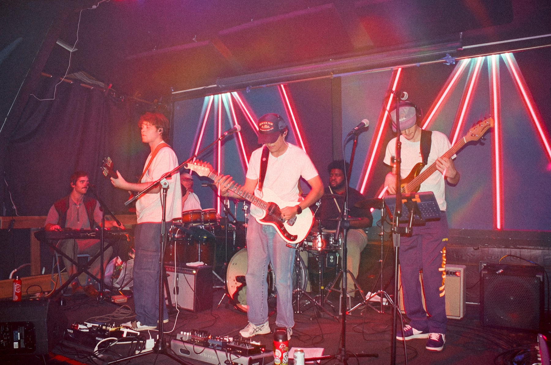 Dylan Miles and band on stage under pink neon